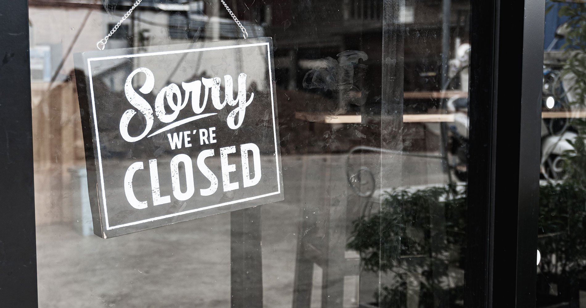 glass door with sign reading sorry we are closed